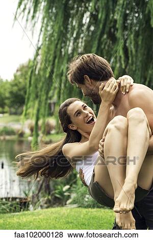 Young man playfully carrying girlriend View Large Photo Image Stock Photo - Young man playfully carrying girlriend. Fotosearch