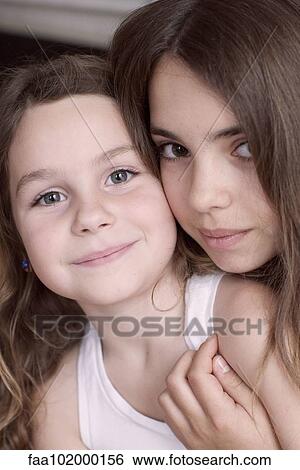 "Young sisters, portrait" View Large Photo Image Stock Photograph - "Young sisters, portrait". Fotosearch