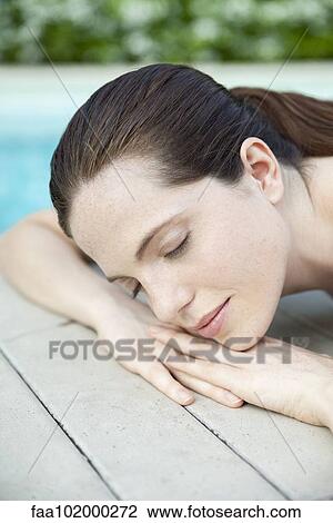 "Young woman lying down, sunbathing with eyes closed, cropped" View Large Photo Image Stock Image - "Young woman lying down, sunbathing with eyes closed, cropped". Fotosearch