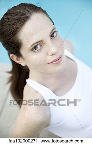 Stock Image - "Young woman sunbathing, portrait". Fotosearch