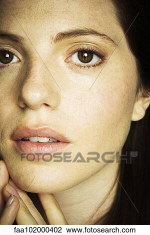 Stock Image - "Young woman's face, close-up". Fotosearch