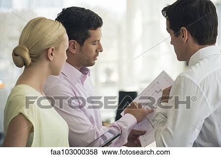 Architects discussing blueprints View Large Photo Image Stock Photo - Architects discussing blueprints. Fotosearch