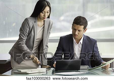 Assistant helping manager in office View Large Photo Image Stock Image - Assistant helping manager in office. Fotosearch