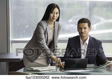 Associates working as team in office View Large Photo Image Stock Image - Associates working as team in office. Fotosearch