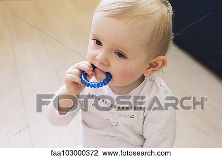 Baby chewing on teething ring View Large Photo Image Stock Image - Baby chewing on teething ring. Fotosearch