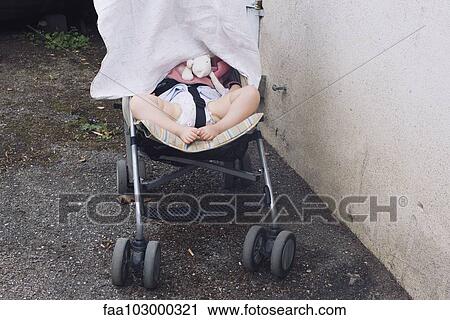 Baby napping in stroller with face covered by blanket View Large Photo Image Stock Image - Baby napping in stroller with face covered by blanket. Fotosearch