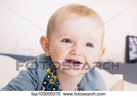 Stock Image - "Baby smiling, portrait". Fotosearch