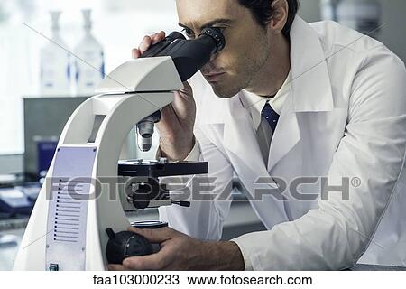 Biologist using microscope View Large Photo Image Stock Image - Biologist using microscope. Fotosearch