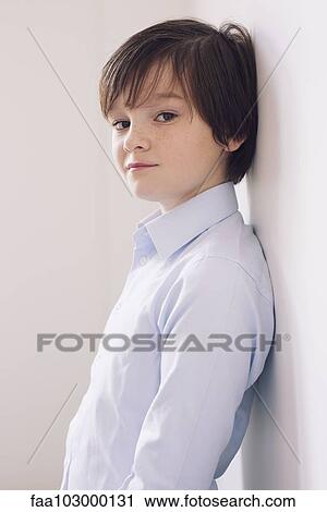 Stock Image - "Boy leaning against wall, portrait". Fotosearch