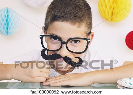 Boy wearing fake mustache and glasses at a birthday party View Large Photo Image Stock Image - Boy wearing fake mustache and glasses at a birthday party. Fotosearch