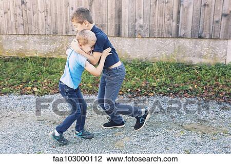 Boys playing together outdoors View Large Photo Image Stock Image - Boys playing together outdoors. Fotosearch