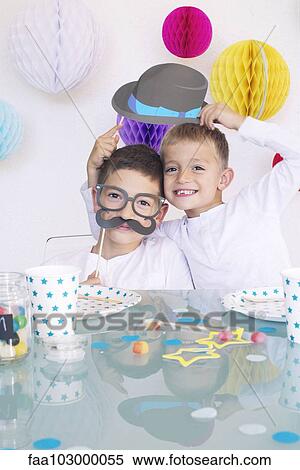 Boys wearing funny disguises at birthday party View Large Photo Image Stock Photography - Boys wearing funny disguises at birthday party. Fotosearch