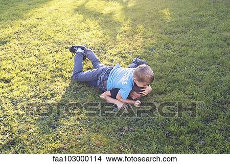 Boys wrestling on lawn View Large Photo Image Picture - Boys wrestling on lawn. Fotosearch