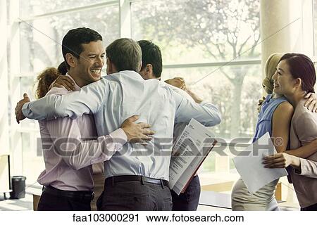 Stock Image - Business associates celebrating team success. Fotosearch