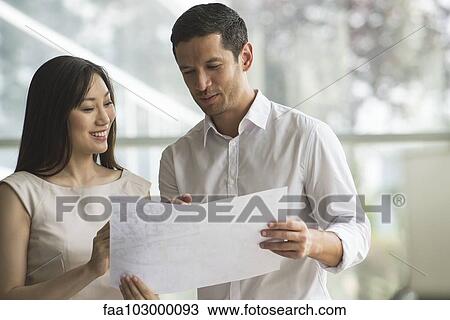 Stock Image - Business associates collaborating. Fotosearch