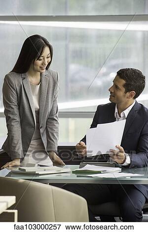 Business associates collaborating View Large Photo Image Stock Photo - Business associates collaborating. Fotosearch