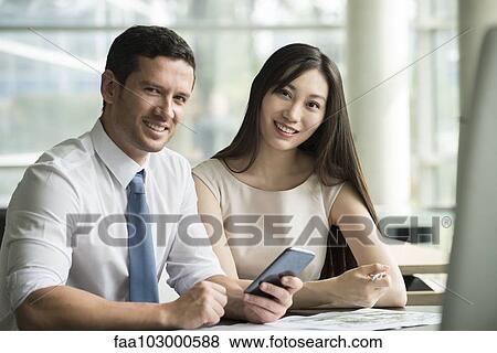 Stock Photo - "Business associates collaborating, portrait". Fotosearch
