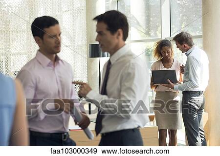 Business associates in animated conversation View Large Photo Image Stock Photo - Business associates in animated conversation. Fotosearch