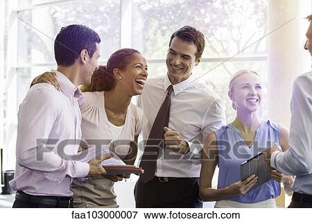 Business associates relaxing together after work View Large Photo Image Stock Photo - Business associates relaxing together after work. Fotosearch