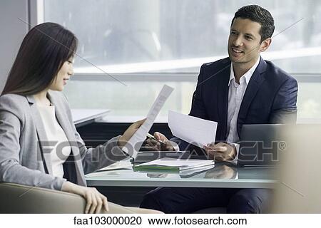 Business associates reviewing document View Large Photo Image Stock Image - Business associates reviewing document. Fotosearch
