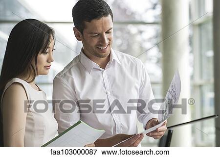 Stock Photo - Business associates sharing ideas. Fotosearch