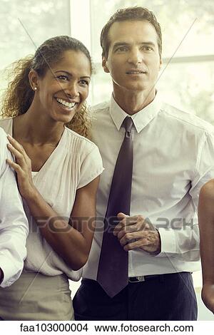 Picture - Business associates sharing lighthearted moment together. Fotosearch