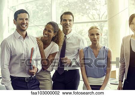 Stock Image - Business associates sharing lighthearted moment together. Fotosearch