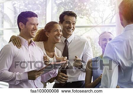 Stock Photo - Business associates sharing lighthearted moment together. Fotosearch