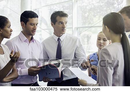 Business professionals collaborating in high pressure setting View Large Photo Image Stock Photography - Business professionals collaborating in high pressure setting. Fotosearch