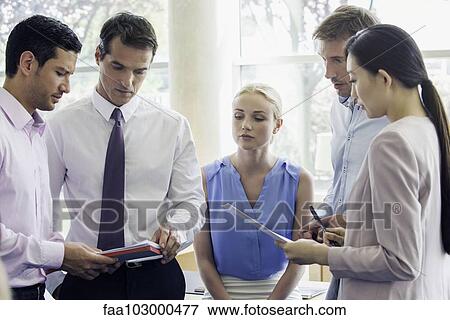 Stock Photo - Business professionals collaborating. Fotosearch