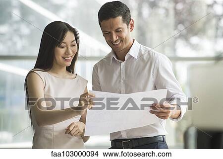 Business professionals reviewing document together View Large Photo Image Picture - Business professionals reviewing document together. Fotosearch