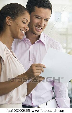 Stock Photography - Business professionals sharing good news. Fotosearch