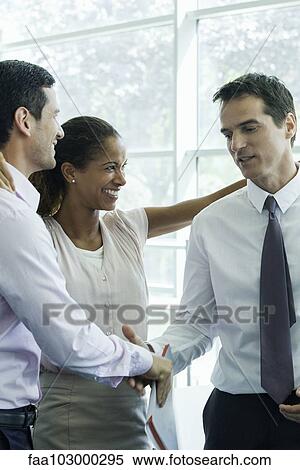 Business team members congratulating each other View Large Photo Image Stock Photography - Business team members congratulating each other. Fotosearch