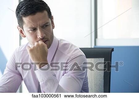 Stock Image - Businessman looking away concerned. Fotosearch