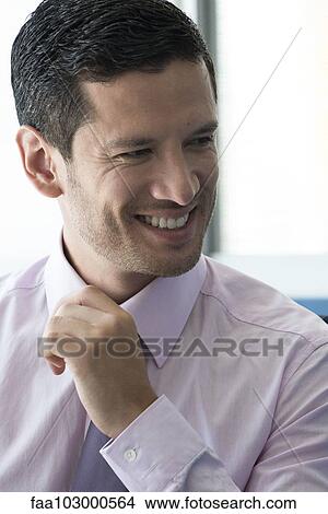 Businessman looking away pleased View Large Photo Image Picture - Businessman looking away pleased. Fotosearch