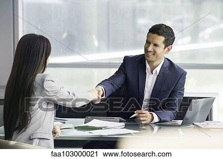 Businessman shaking hands with client View Large Photo Image Stock Image - Businessman shaking hands with client. Fotosearch