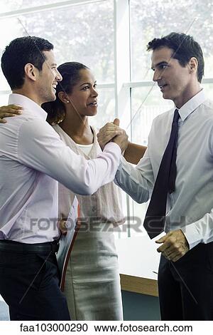 Stock Image - Businessmen congratulating each other. Fotosearch