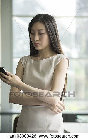 Businesswoman text messaging View Large Photo Image Stock Photograph - Businesswoman text messaging. Fotosearch