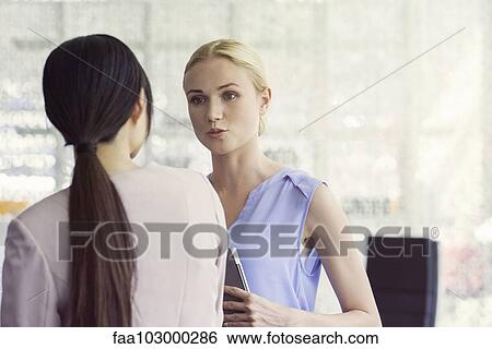 Businesswomen chatting View Large Photo Image Stock Photograph - Businesswomen chatting. Fotosearch
