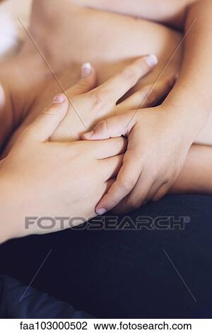 Stock Image - "Children hoding mother's hand, cropped". Fotosearch