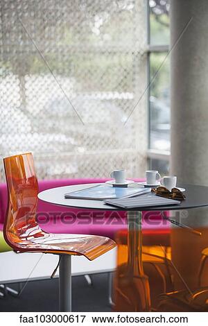 "Coffee cups, notebooks, and sunglasses left on table in cafe" View Large Photo Image Stock Photo - "Coffee cups, notebooks, and sunglasses left on table in cafe". Fotosearch