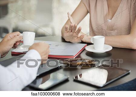 "Colleagues having informal meeting in cafe, cropped" View Large Photo Image Stock Photo - "Colleagues having informal meeting in cafe, cropped". Fotosearch
