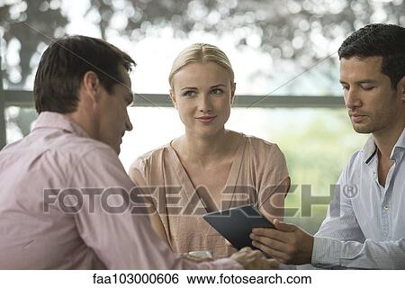 Stock Photograph - Colleagues having working coffee break. Fotosearch