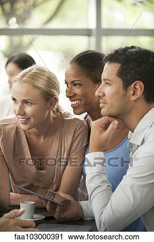 Colleagues listening attentively to story during coffee break View Large Photo Image Stock Image - Colleagues listening attentively to story during coffee break. Fotosearch
