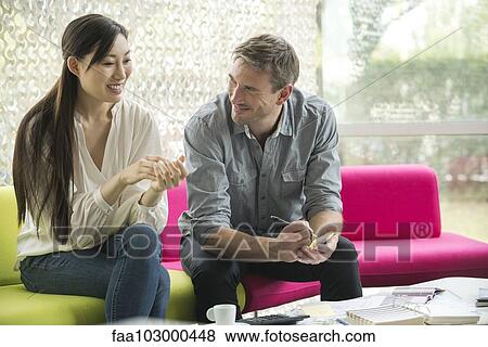 Colleagues looking at color swatches together View Large Photo Image Stock Photo - Colleagues looking at color swatches together. Fotosearch
