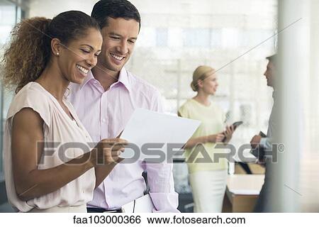 Stock Photograph - Colleagues pleased by results. Fotosearch