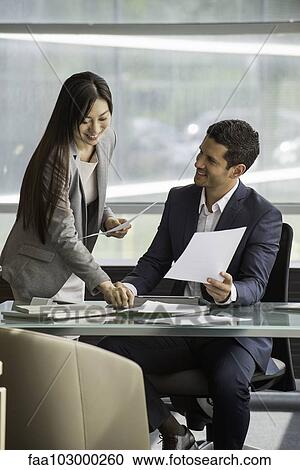Colleagues working together in office View Large Photo Image Stock Image - Colleagues working together in office. Fotosearch