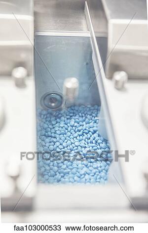 Compartment full of pills in industrial packaging equipment View Large Photo Image Stock Image - Compartment full of pills in industrial packaging equipment. Fotosearch