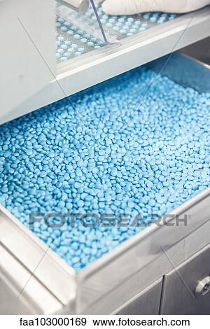 Compartment full of pills in industrial packaging equipment View Large Photo Image Stock Photo - Compartment full of pills in industrial packaging equipment. Fotosearch