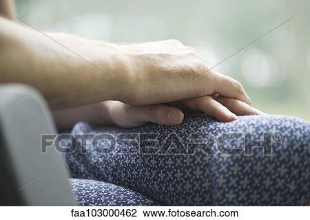 "Couple holding hands, close-up" View Large Photo Image Stock Image - "Couple holding hands, close-up". Fotosearch